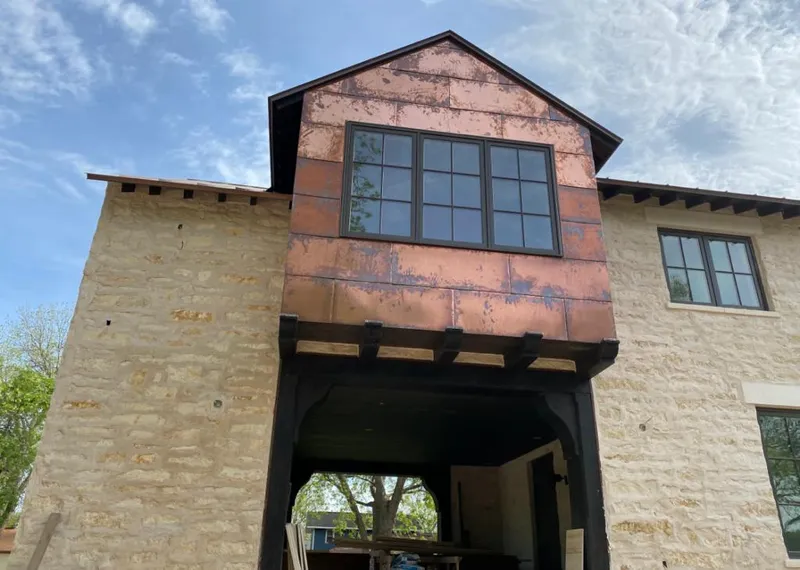 Copper metal panel facade on a stone building for Metal Roof Coating in Orrville